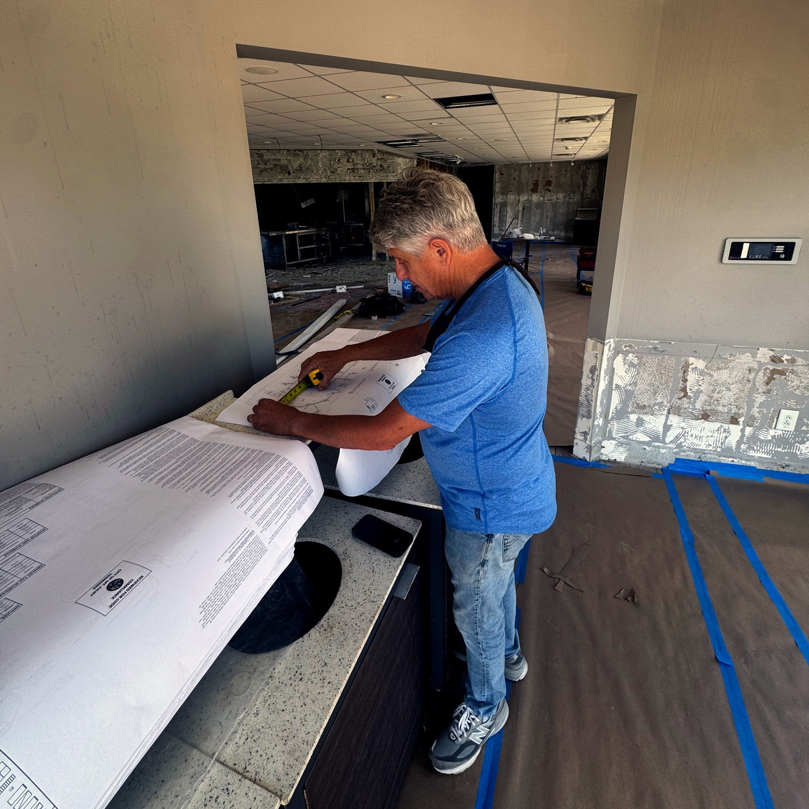 Harpeth Air team member measuring building plans on site